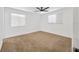 Clean bedroom with neutral carpet, two windows, and a ceiling fan at 2425 Anderson, Mulberry, FL 33860