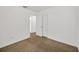 Bedroom with neutral carpet, white walls, and a door leading to the bathroom at 2425 Anderson, Mulberry, FL 33860