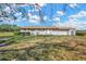 Charming single-story home with a well-manicured lawn and a small shed on the side at 2425 Anderson, Mulberry, FL 33860