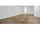Open-concept living room with beige carpeting and white paint throughout at 2425 Anderson, Mulberry, FL 33860