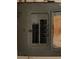 Close-up of an open, aged electrical panel box with handwritten labels and notes at 2610 Tennessee Rd, Lakeland, FL 33815