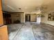 Spacious living room featuring vintage ceiling fans and an open floor plan; needs renovation at 2610 Tennessee Rd, Lakeland, FL 33815