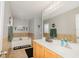 Well-lit bathroom with a soaking tub, neutral paint, and a large mirror over the sink and vanity at 1808 Ashton E Dr, St Cloud, FL 34771