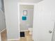 Cozy bathroom featuring a toilet, vanity, towel bar and decorative 'get naked' sign at 1808 Ashton E Dr, St Cloud, FL 34771
