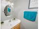 Bathroom featuring a single sink, round mirror, and modern fixtures at 1808 Ashton E Dr, St Cloud, FL 34771