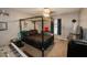 Comfortable bedroom with four-poster bed, modern lighting, and neutral walls at 1808 Ashton E Dr, St Cloud, FL 34771