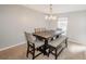 Bright dining room with a stylish chandelier, large table with chairs and bench seating at 1808 Ashton E Dr, St Cloud, FL 34771