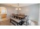 Inviting dining area with a chandelier, dark wood table, and seating for six at 1808 Ashton E Dr, St Cloud, FL 34771