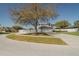 Charming two-story home with a three-car garage, mature tree, and manicured front yard at 1808 Ashton E Dr, St Cloud, FL 34771