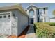 Beautiful exterior showcasing the front entrance and attached two-car garage of the home at 1808 Ashton E Dr, St Cloud, FL 34771