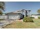 Charming two-story home with a well-maintained lawn and a spacious two-car garage at 1808 Ashton E Dr, St Cloud, FL 34771