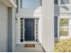 Stylish front door with sidelights, enhanced by a fresh coat of paint and bright white trim at 1808 Ashton E Dr, St Cloud, FL 34771