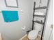 Compact half bathroom, complete with tiled flooring and decorative ladder shelf for a cozy touch at 1808 Ashton E Dr, St Cloud, FL 34771