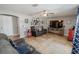 Cozy living room with tile floors, a ceiling fan, and plenty of wall decor at 1808 Ashton E Dr, St Cloud, FL 34771