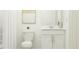Clean bathroom featuring a toilet, vanity with sink, and shower with white tiling and accents at 2109 Lasso Loop, Eagle Lake, FL 33839