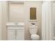 Clean bathroom with white vanity, toilet, shower with curtain, and simple decor, creating a fresh and functional space at 2109 Lasso Loop, Eagle Lake, FL 33839