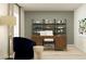 Stylish home office featuring a wooden desk, comfortable seating, modern shelving, and ample light for a productive workspace at 2109 Lasso Loop, Eagle Lake, FL 33839