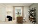 Functional home office with wooden desk, ergonomic chair, stylish shelving, and natural light for productivity at 2109 Lasso Loop, Eagle Lake, FL 33839