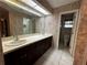 Bright bathroom with dual sinks, dark wood cabinets, and decorative wallpaper at 3050 Carolina Ave, Lakeland, FL 33803