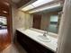 Bathroom boasts dual sinks, a large mirror, and access to a closet at 3050 Carolina Ave, Lakeland, FL 33803