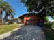 Inviting home featuring a paver driveway, attached garage, and a mix of stone and wood exterior at 3050 Carolina Ave, Lakeland, FL 33803