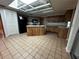Classic kitchen featuring a central island with seating, warm wood cabinets, and modern appliances at 3050 Carolina Ave, Lakeland, FL 33803