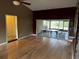 Bright living room with hardwood floors, a ceiling fan, and glass doors leading to the outdoor patio at 3050 Carolina Ave, Lakeland, FL 33803