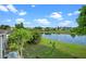 The backyard offers a serene pond view, a manicured lawn, and patio seating, enhancing the property's appeal at 1322 Aguacate Ct, Orlando, FL 32837
