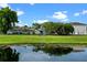 Spacious backyard with pond, lush green grass, and beautiful landscaping at 1322 Aguacate Ct, Orlando, FL 32837