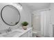 Bright bathroom featuring an oval mirror and a shower-tub combo at 1322 Aguacate Ct, Orlando, FL 32837