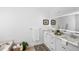 Bright bathroom with a double sink vanity, backlit mirror, and soaking tub at 1322 Aguacate Ct, Orlando, FL 32837