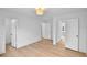 Bright, empty bedroom with light wood-look floors and multiple doorways at 1322 Aguacate Ct, Orlando, FL 32837