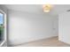 Bright bedroom with modern light fixture, light wood floor, and double-hung window at 1322 Aguacate Ct, Orlando, FL 32837