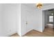 Minimalist entryway featuring a white door, light fixture, and light wood-look floors at 1322 Aguacate Ct, Orlando, FL 32837