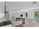 Bright kitchen with stainless steel appliances, quartz countertops, view of the backyard with pond and patio at 1322 Aguacate Ct, Orlando, FL 32837