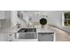 Close-up of a modern kitchen sink with stainless steel faucet, quartz countertop, and white cabinets at 1322 Aguacate Ct, Orlando, FL 32837