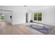 Bright living room with wood-look floors, neutral walls, and views of the updated kitchen at 1322 Aguacate Ct, Orlando, FL 32837