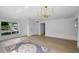 Bright living room with modern chandelier, wood-look floors, neutral walls, and abundant natural light at 1322 Aguacate Ct, Orlando, FL 32837