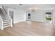 Bright living room featuring modern lighting, wood floors, and a staircase at 1322 Aguacate Ct, Orlando, FL 32837