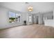 Bright living room featuring light wood floors, a view to the exterior and entrances to additional rooms at 1322 Aguacate Ct, Orlando, FL 32837
