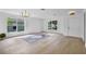 The expansive, light-filled living room features wood-look floors and ample natural light at 1322 Aguacate Ct, Orlando, FL 32837