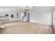 Bright living room featuring light wood floors, recessed lighting, and an open floor plan into the modern kitchen at 1322 Aguacate Ct, Orlando, FL 32837