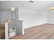 Bright open loft space featuring wood railing and light wood floors throughout the area at 1322 Aguacate Ct, Orlando, FL 32837