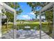 Patio with chairs and table overlooking a scenic pond and green space at 1322 Aguacate Ct, Orlando, FL 32837