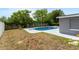 Backyard showcasing an inviting pool, a diving board, and mature landscaping, ready for summer fun at 14464 Sw 34Th Terrace Rd, Ocala, FL 34473