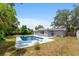Expansive backyard featuring a sparkling pool, diving board, and plenty of space for outdoor activities at 14464 Sw 34Th Terrace Rd, Ocala, FL 34473