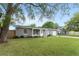 Lovely one-story home with a green lawn, an attached one-car garage, and mature trees at 14464 Sw 34Th Terrace Rd, Ocala, FL 34473