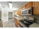 A detailed view of the kitchen's appliances and hardwood cabinetry at 14464 Sw 34Th Terrace Rd, Ocala, FL 34473