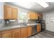 Well-lit kitchen featuring wood cabinets, stainless steel appliances, and stone countertops at 14464 Sw 34Th Terrace Rd, Ocala, FL 34473