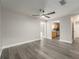 A light, airy living room with gray floors, a ceiling fan, and open access to the kitchen at 14464 Sw 34Th Terrace Rd, Ocala, FL 34473